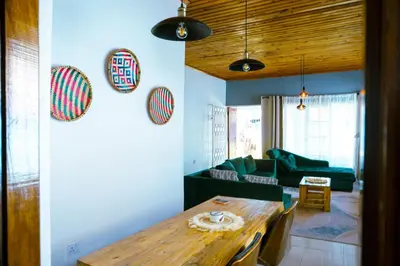 a living room with a table and a couch at Garden Villa Homestay in Arusha