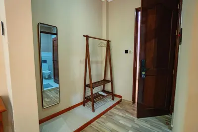 a room with a bathroom with a mirror and a door at La Mama Hotel in Uru