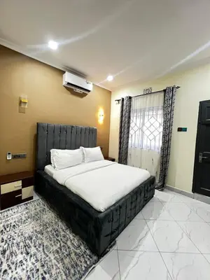 a bedroom with a large bed in a room at Hadraj Sokoine Apartment1 in Arusha