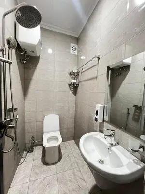 a bathroom with a toilet and a sink at Hadraj Sokoine Apartment1 in Arusha