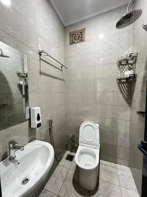 a bathroom with a toilet and a sink at Hadraj Sokoine Apartment2 in Arusha