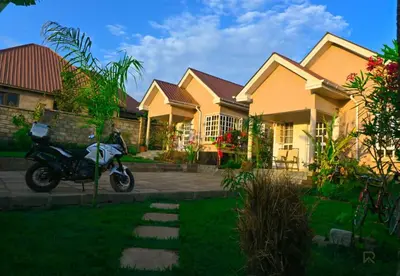 a motorcycle parked in front of some houses at Rejoice Evermore Homes in Arusha
