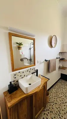 a bathroom with a white sink and a mirror at Tulusia Lake View in Arusha