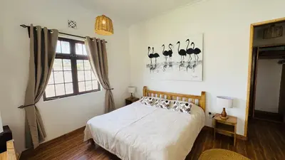 a bedroom with a bed with birds on the wall at Tulusia Lake View in Arusha