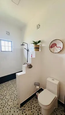 a white bathroom with a toilet and a staircase at Tulusia Lake View in Arusha