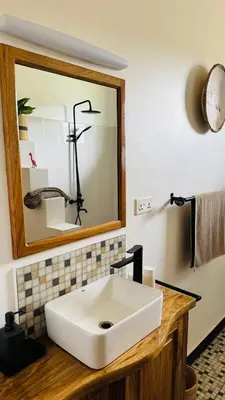a bathroom with a white sink and a mirror at Tulusia Lake View in Arusha