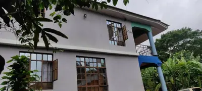 a white house with windows on the side of it at WauTaMaDuNi Homestay in Usa River