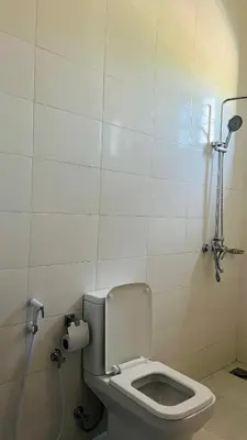 a bathroom with a toilet in a stall at African Jacana Inn and Camps in Mto wa Mbu
