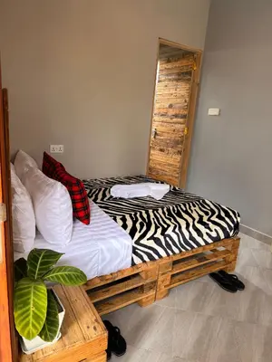 a bed in a room with a zebra patterned mattress at Baraka Home in Arusha