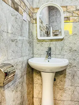 a bathroom with a sink and a mirror at Havijo Residence