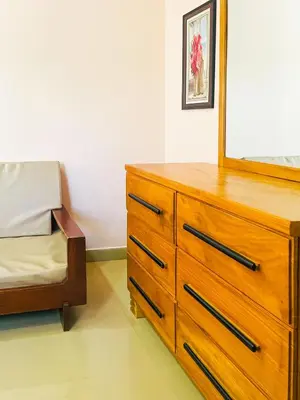 a bedroom with a dresser with a mirror and a bed at Havijo Residence