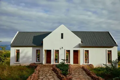 a white house with a black roof at Tarangire Luxury Hideaway in Mbesi