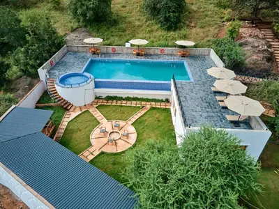 an overhead view of a swimming pool with umbrellas at Tarangire Luxury Hideaway in Mbesi