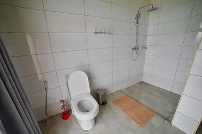 a bathroom with a toilet and a shower at Tarangire Luxury Hideaway in Mbesi