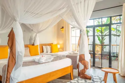 a bedroom with two beds and a large window at Pamoja Farm Villas in Karatu