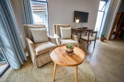 a living room with two chairs and a table at Pamoja Farm Villas in Karatu