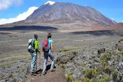 two people standing on top of a mountain at Milele Homestay in Boma la Ngombe
