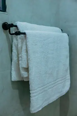 two towels are hanging on a towel rack in a bathroom at Dodo homes in Uru