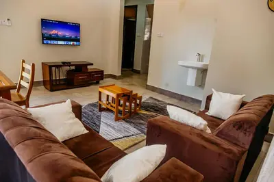 a living room with a couch and a tv at Dodo homes in Uru
