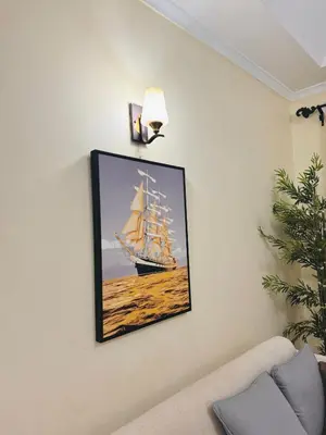 a picture of a ship hanging on a wall at In arusha nests in Arusha