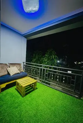 a room with a balcony with green grass at In arusha nests in Arusha