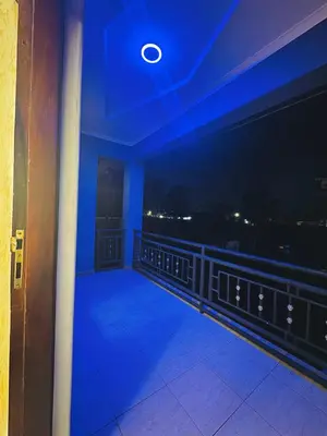 a room with a view of a balcony at night at In arusha nests in Arusha