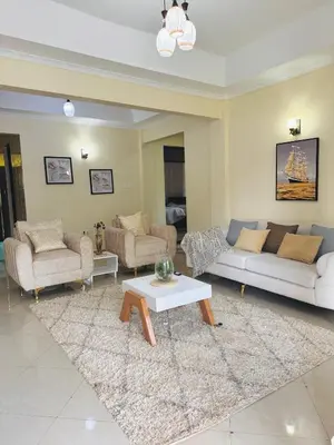a living room with couches and a coffee table at In arusha nests in Arusha