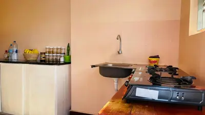 a kitchen with a stove and a sink at Safari Roots Hostel in Arusha