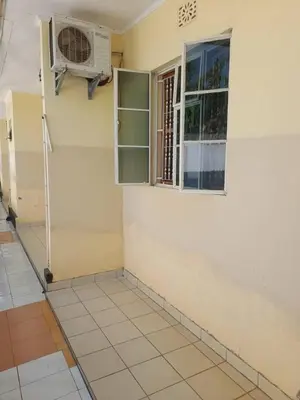 a room with a window and a air conditioner at Rose Home in Moshi