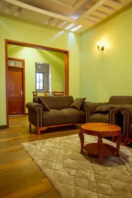 a living room with two couches and a table at Sarnah Apartments in Arusha
