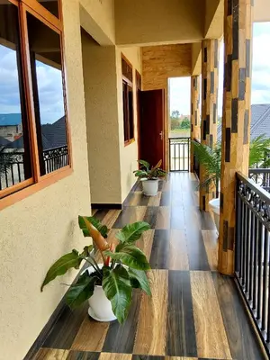 a porch with two potted plants on a building at Sarnah Apartments in Arusha