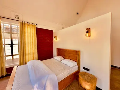 a bedroom with a bed and a window at Nalala in Arusha