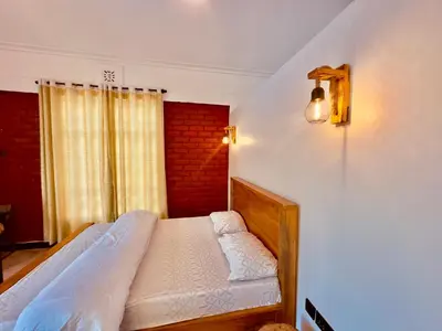 a bedroom with a bed and a window at Nalala in Arusha