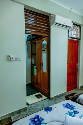 a room with a bedroom with a door and a bed at Bellevie Homestay in Uru