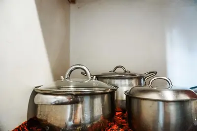 three metal pots sitting on top of a stove at Garden Villa 5BR Home Near Road,Nature and City Life in Arusha
