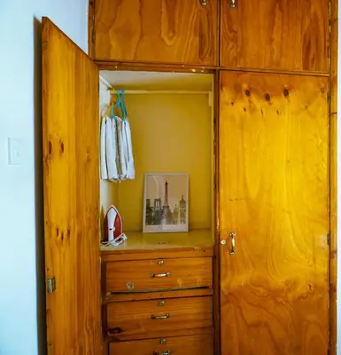 a wooden cabinet with a dresser in a room at Garden Villa 5BR Home Near Road,Nature and City Life in Arusha