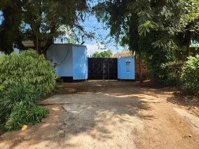 two blue toilets sitting in a yard under a tree at Garden Inn Eco Stay in Msaranga