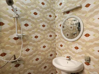 a bathroom with a sink and a mirror at Garden Inn Eco Stay in Msaranga