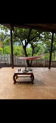 a table in a pavilion with a hammock at The Fort Valley BnB , Karatu in Karatu