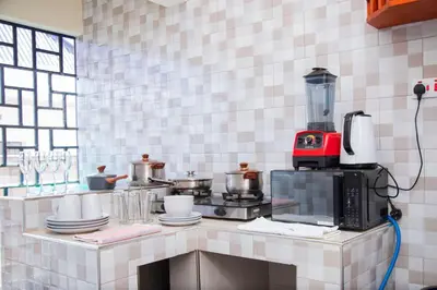a kitchen with a counter with a coffee maker on it at Apollo Villa homestay in Arusha