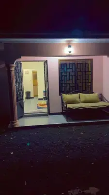a reflection of a bed in a mirror at Apollo Villa homestay in Arusha