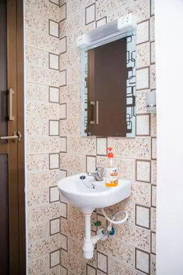 a bathroom with a sink and a mirror at Apollo Villa homestay in Arusha