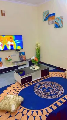 a living room with a couch and a table with a rug at Apollo Villa homestay in Arusha