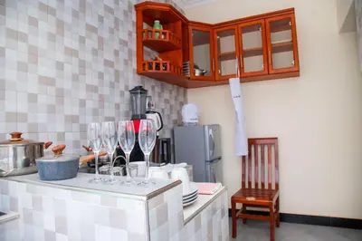 a kitchen with wine glasses on a counter at Apollo Villa homestay in Arusha