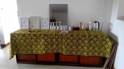 a table with a yellow patterned table cloth on it at Mount Meru Baraka House