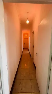 an empty hallway with a hallway leading into a room at Mount Meru Baraka House