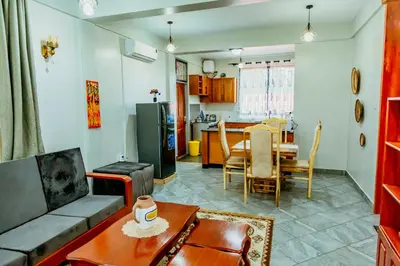 a living room with a couch and a table at Bellevie Homestays in Uru