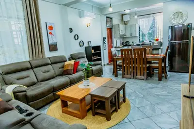 a living room with a couch and a table at Bellevie Homestays in Uru