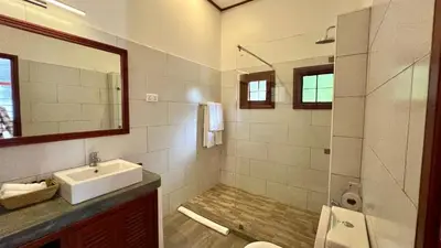 a bathroom with a sink and a shower at Green Hills Lodge in Usa River