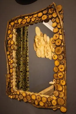 a mirror with a wooden frame with beads on it at Simba homes in Arusha